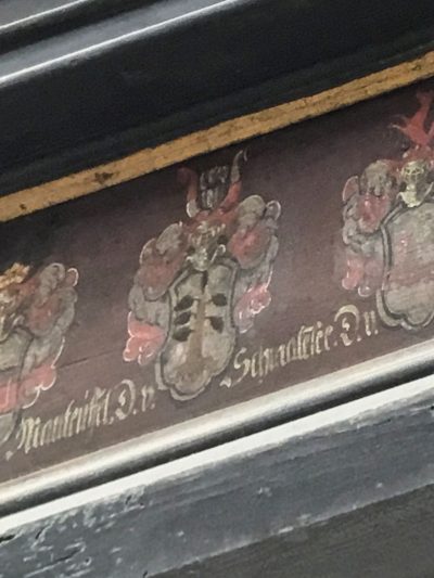 Family crest at the bottom of the painting